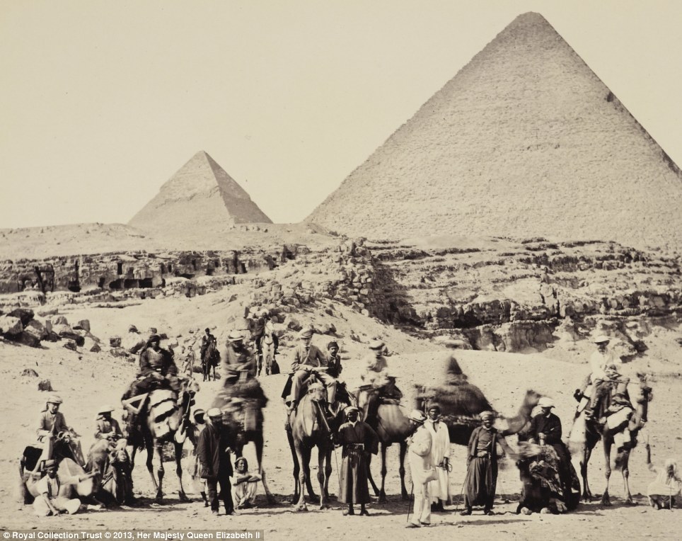 Sands of time: The Royal party pictured in front of the Pyramids of Giza in March 1862 with the then 20-year-old Prince of Wales sitting in a light jacket and cap on the third standing camel from left